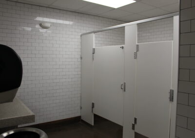 bathroom with subway tiles and white stalls