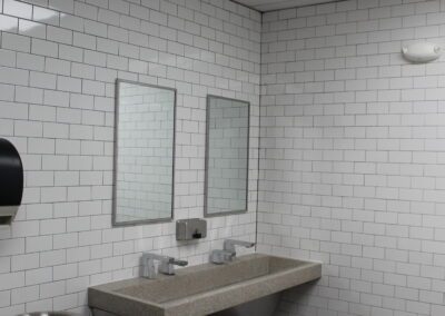 subway tiled bathroom with modern sinks