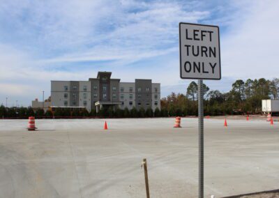 left turn only sign with a hotel in the background